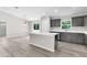 Bright kitchen featuring an island with quartz countertops, gray cabinets, and modern appliances at 14631 Se 95Th Ct, Summerfield, FL 34491