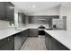 Well-equipped kitchen with stainless steel appliances, gray cabinetry, and a center island with quartz countertops at 14631 Se 95Th Ct, Summerfield, FL 34491