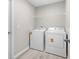 Convenient laundry room with washer, dryer, and overhead shelving for easy storage at 14631 Se 95Th Ct, Summerfield, FL 34491