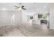 Open floor plan of living room flowing into a modern kitchen with stainless steel appliances at 14631 Se 95Th Ct, Summerfield, FL 34491