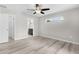 Bright main bedroom with wood flooring, ceiling fan and ensuite bathroom access at 14631 Se 95Th Ct, Summerfield, FL 34491