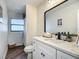 Modern bathroom featuring a new vanity with quartz countertop and a framed mirror at 1611 Canal, Tavares, FL 32778