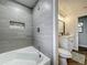 Updated bathroom featuring tub with tile surround, recessed niche, and modern fixtures at 1611 Canal, Tavares, FL 32778