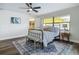 Sunlit bedroom with hardwood floors, ceiling fan, ensuite, and a view of the backyard at 1611 Canal, Tavares, FL 32778