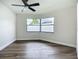 Sunlit bedroom showcasing wood-look floors and a bay window enhancing natural light at 1611 Canal, Tavares, FL 32778