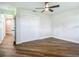 Bright bedroom featuring hardwood floors, ceiling fan, and a large closet at 1611 Canal, Tavares, FL 32778