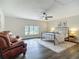 Bright bedroom with hardwood floors, ceiling fan, and a window with a neighborhood view at 1611 Canal, Tavares, FL 32778