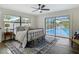 Sunlit bedroom with hardwood floors, ceiling fan, backyard and pool views at 1611 Canal, Tavares, FL 32778