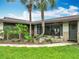 Beautiful exterior with mature palm trees, stone accents, and a well-maintained lawn at 1611 Canal, Tavares, FL 32778