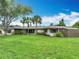 Beautifully landscaped home with a well-manicured lawn and mature palm trees providing shade at 1611 Canal, Tavares, FL 32778