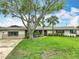 Attractive home with lush lawn, mature trees, and stone accents create a inviting curb appeal at 1611 Canal, Tavares, FL 32778