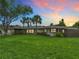 Charming single-story home with lush landscaping and a well-manicured front yard at 1611 Canal, Tavares, FL 32778