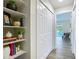Bright hallway with open shelves, modern decor, closet and serene views of the pool area beyond at 1611 Canal, Tavares, FL 32778