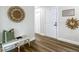 Hallway featuring a decorated bench, doors, and unique wall decor, showcasing a welcoming entrance at 1611 Canal, Tavares, FL 32778