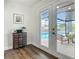 Hallway leading to the pool area, showcases stylish furnishings, decor and wood flooring at 1611 Canal, Tavares, FL 32778