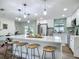 Bright kitchen with large island, bar seating, pendant lights and stainless steel appliances at 1611 Canal, Tavares, FL 32778