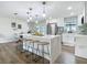 Modern kitchen boasting an island with seating, quartz countertops, and stainless steel appliances at 1611 Canal, Tavares, FL 32778