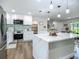 Modern kitchen with stainless steel appliances, large island, and stylish pendant lighting at 1611 Canal, Tavares, FL 32778