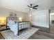 Comfortable main bedroom with hard wood floors, a ceiling fan, stylish furnishings, and natural light at 1611 Canal, Tavares, FL 32778