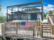 This inviting pool area features a screened enclosure, wooden deck and an American flag adding patriotic charm at 1611 Canal, Tavares, FL 32778