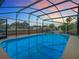 A screened-in pool with water views provides a relaxing oasis at 1611 Canal, Tavares, FL 32778