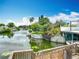 Picturesque waterfront view of a serene canal with lush landscaping and private docks on a sunny day at 1611 Canal, Tavares, FL 32778