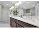 Bathroom with a double sink vanity, large mirror, and glass-enclosed shower at 16300 County Road 455 # 202, Montverde, FL 34756