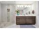 Modern bathroom with double vanity, glass shower enclosure, and stylish tile accents at 16300 County Road 455 # 202, Montverde, FL 34756