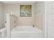 Relaxing bathroom featuring a soaking tub, neutral tiles, and soft lighting at 16300 County Road 455 # 202, Montverde, FL 34756