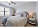 Cozy bedroom with a plush bed, decorative pillows, and a view from the window at 16300 County Road 455 # 202, Montverde, FL 34756