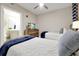 Comfortable bedroom featuring twin beds, a dresser with a TV, and an ensuite bathroom, for seamless living at 16300 County Road 455 # 202, Montverde, FL 34756