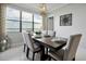 Elegantly staged dining room featuring a modern table set for six with waterfront view at 16300 County Road 455 # 202, Montverde, FL 34756