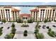 Elegant gated entrance to the condo complex, featuring lush landscaping and ample parking at 16300 County Road 455 # 202, Montverde, FL 34756