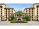 Beautiful resort-style exterior view of building featuring manicured landscaping and palm trees at 16300 County Road 455 # 202, Montverde, FL 34756
