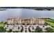 Luxury condos with a pool, stunning lake views, lush greenery, and manicured landscaping at 16300 County Road 455 # 202, Montverde, FL 34756