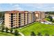 Well-manicured lawn in front of a luxury condo building with pool and patio amenities at 16300 County Road 455 # 202, Montverde, FL 34756