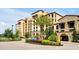 Exterior view of the resort with a palm tree in the circle drive and the building entrance at 16300 County Road 455 # 202, Montverde, FL 34756