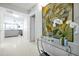 Bright condo foyer with white tile flooring, console table, and an open view to the living room at 16300 County Road 455 # 202, Montverde, FL 34756