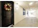 Hallway view outside unit #202 featuring a decorative wreath on the front door at 16300 County Road 455 # 202, Montverde, FL 34756