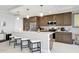 Modern kitchen featuring stainless steel appliances, counter seating, and sleek countertops at 16300 County Road 455 # 202, Montverde, FL 34756