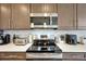 A close-up of a well-equipped kitchen with stainless steel appliances and tile backsplash at 16300 County Road 455 # 202, Montverde, FL 34756