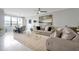A lovely furnished living room with neutral tones and lots of natural light from the large window at 16300 County Road 455 # 202, Montverde, FL 34756