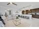 Open living and kitchen space featuring bar stool seating at the kitchen island and modern decor at 16300 County Road 455 # 202, Montverde, FL 34756