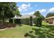 Well-maintained backyard with green grass and neatly trimmed hedges, creating a private outdoor space at 16862 Se 80Th Bellavista Cir, The Villages, FL 32162