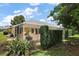 Expansive screened-in patio with lush landscaping and green grass for a private outdoor oasis at 16862 Se 80Th Bellavista Cir, The Villages, FL 32162