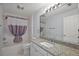 This bathroom features a granite countertop and a shower/tub combination at 16862 Se 80Th Bellavista Cir, The Villages, FL 32162