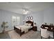 Bedroom with dark wood furniture, decorative rug, and natural lighting at 16862 Se 80Th Bellavista Cir, The Villages, FL 32162