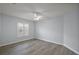 This light-filled room has a ceiling fan and wood-look flooring and neutral paint at 16862 Se 80Th Bellavista Cir, The Villages, FL 32162