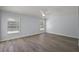 Bright bedroom features wood-look flooring and two windows at 16862 Se 80Th Bellavista Cir, The Villages, FL 32162