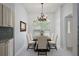 Elegant dining room with chandelier, large window, and stylish furniture, creating a perfect ambiance for meals at 16862 Se 80Th Bellavista Cir, The Villages, FL 32162